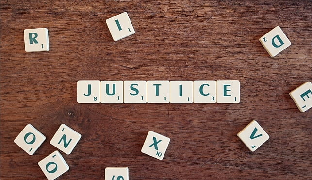 Justice spelt out in scrabble tiles